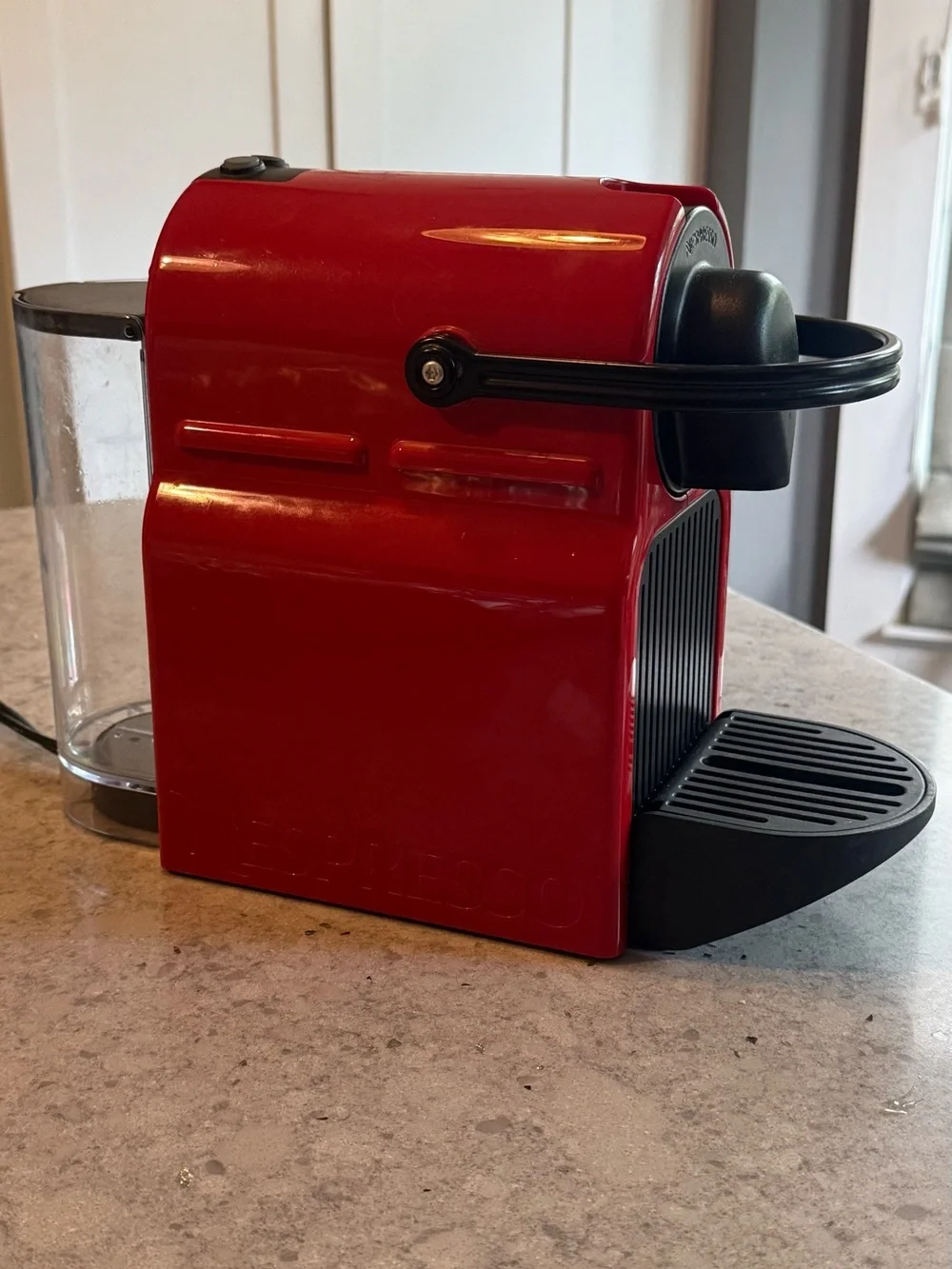 Nespresso Red Single-Serve Espresso Machine with Black Accents.